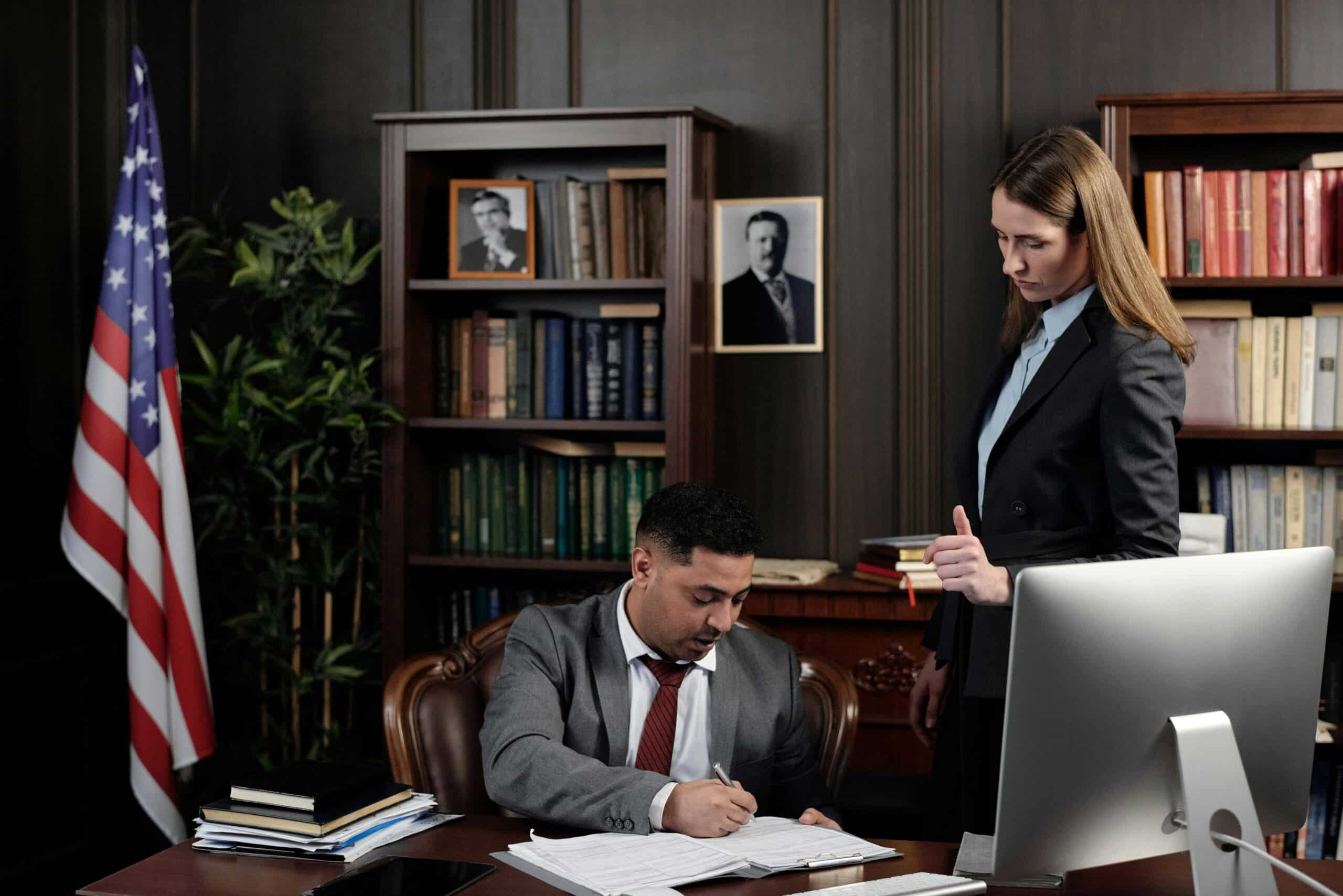 lawyer in their office signing a document